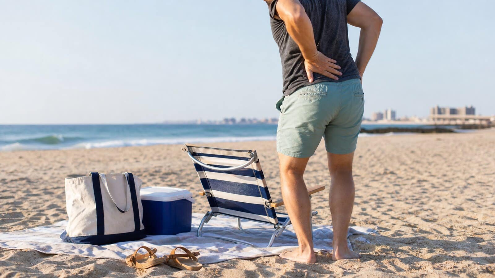 Anonymous beachgoer standing from a low beach chair with low back discomfort on Rockaway Beach