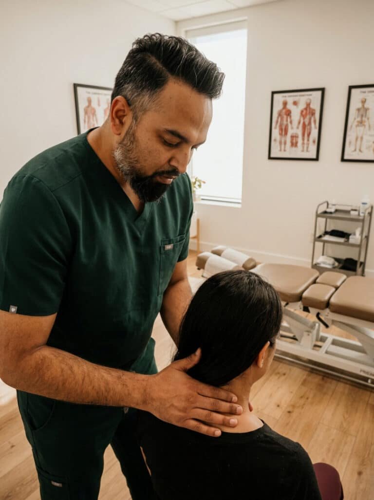 Pinched nerve chiropractor in Brooklyn, Dr. Patel examining a patient neck at Brooklyn Chiropractic Care